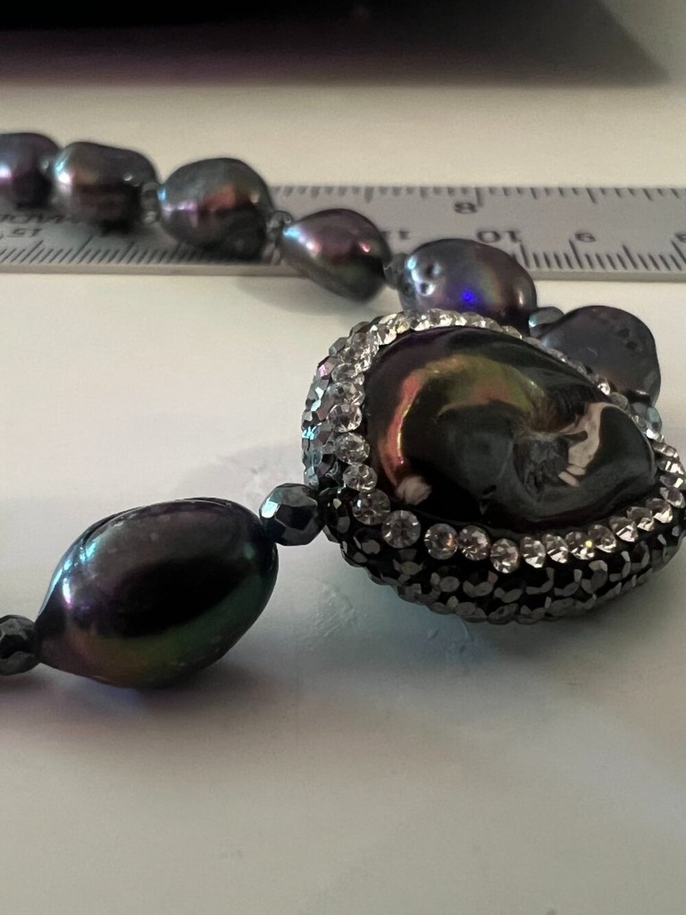 Deep purple natural pearls necklace with a fire agate and rhinestone center ston